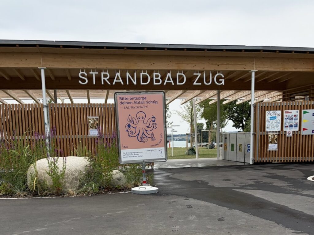 木造の屋根に白い「STRANDBAD ZUG」の文字が掲げられている